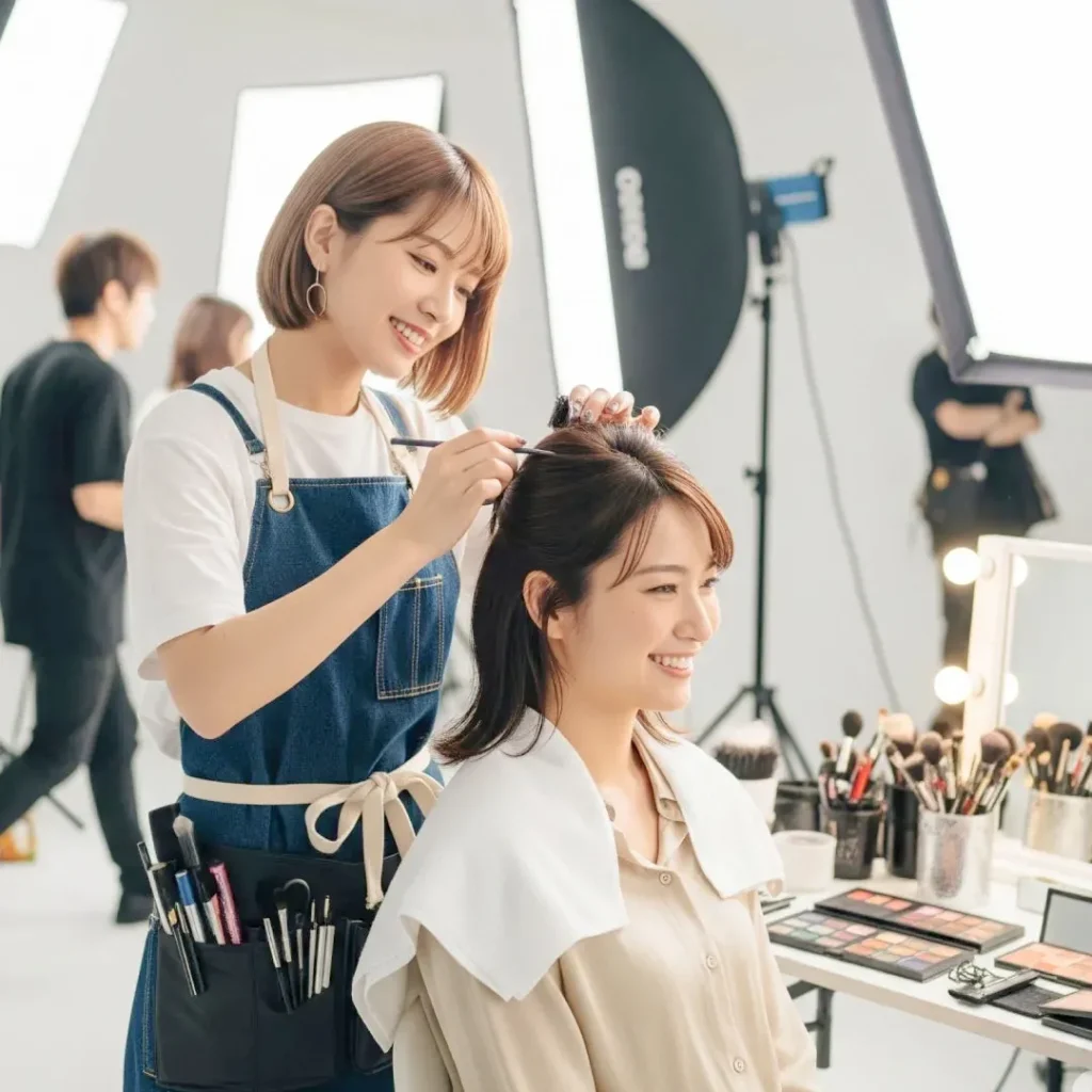 撮影現場でヘアメイキャップアーティストがヘアメイクをしている風景